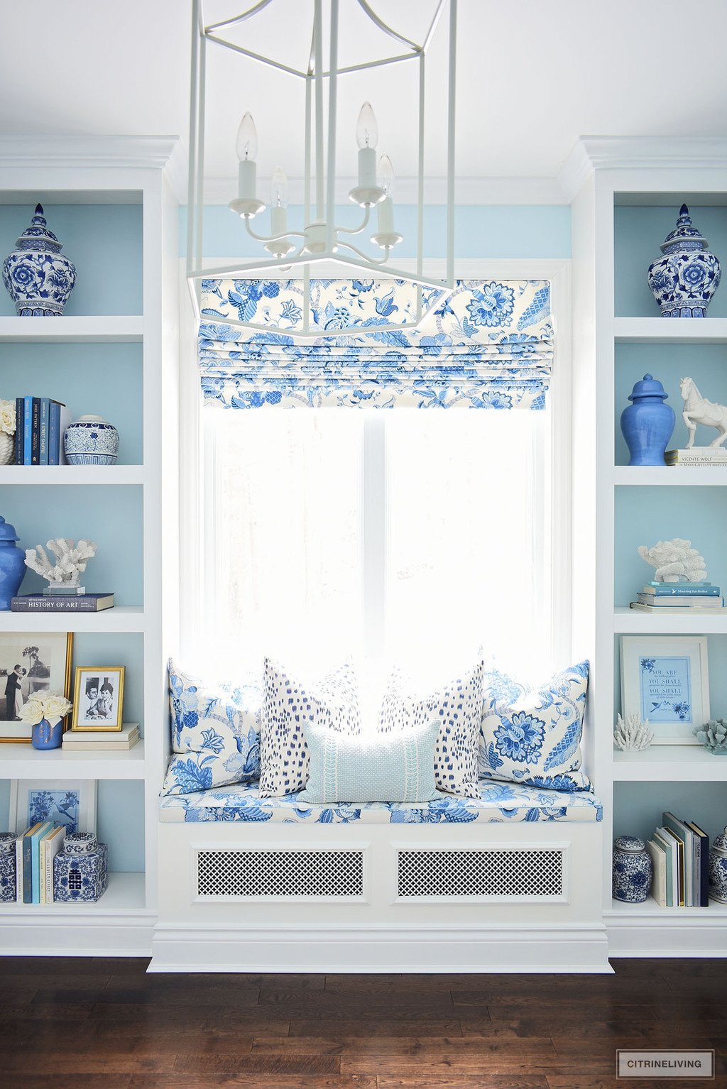 READING NOOK AND BOOKSHELVES IN ELEGANT HOME OFFICE IN BLUE + WHITE CHINOISERIE