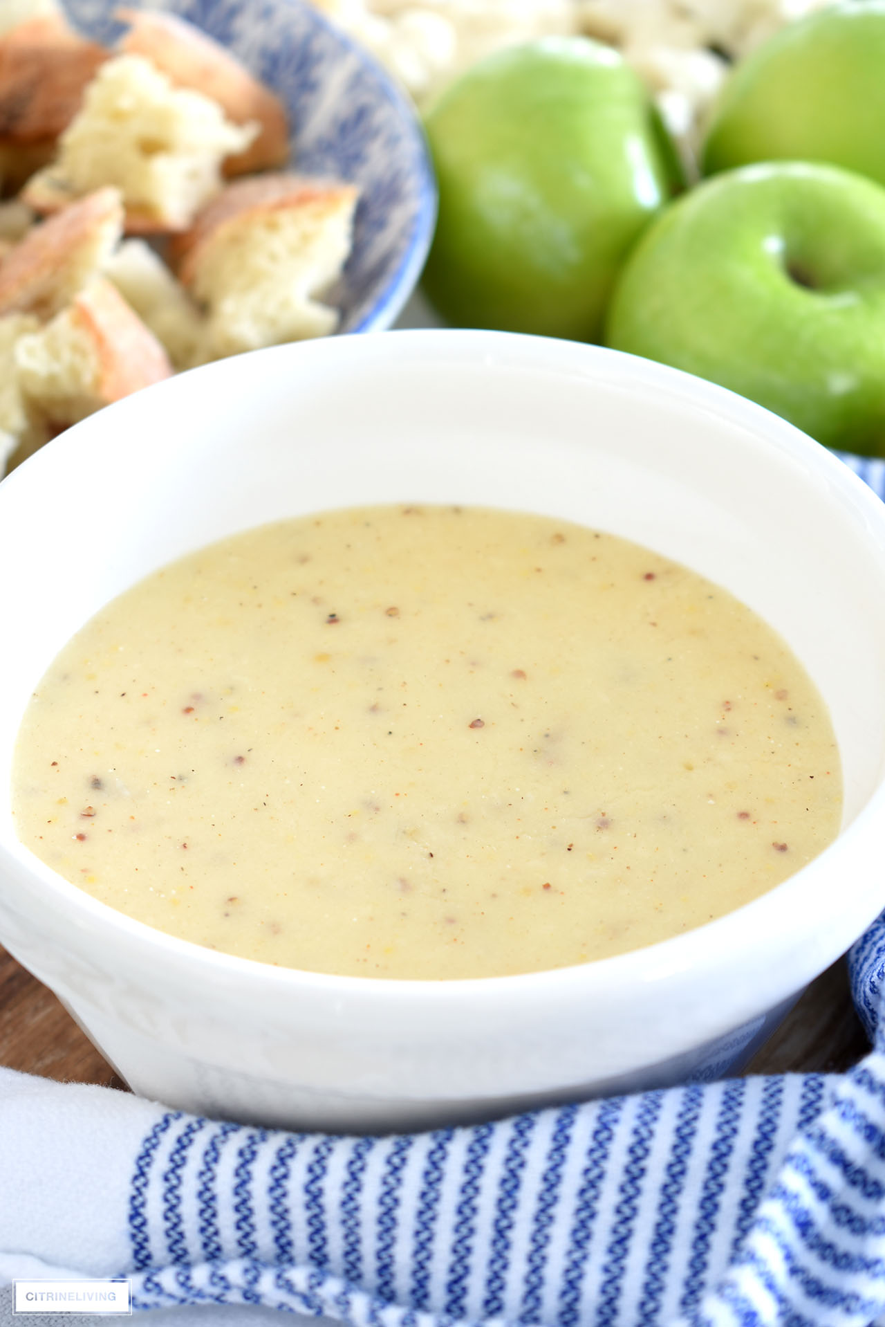 Cheese fondue made with sharp Cheddar cheese, white wine, Dijon mustard, cayenne pepper and nutmeg.