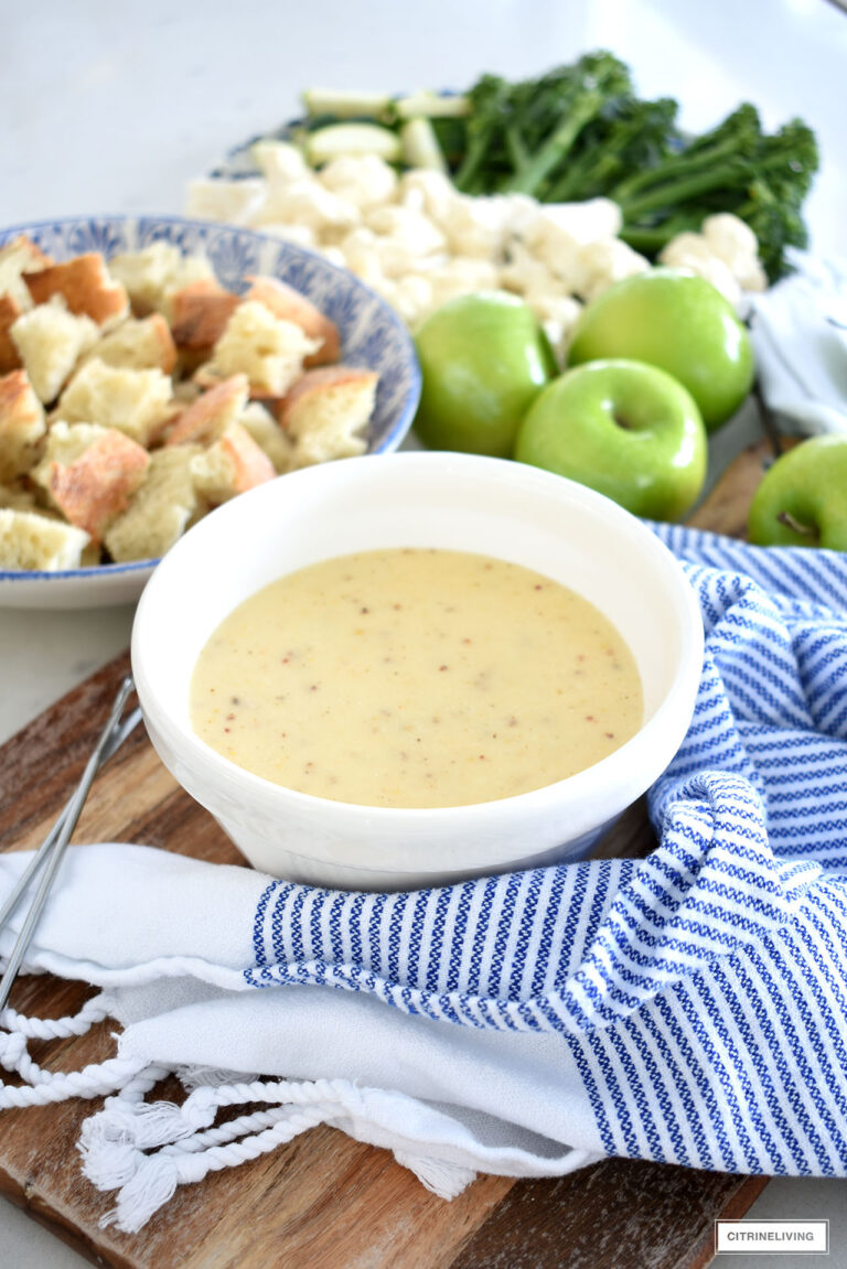 Delicious Cheese Fondue served with crusty bread, green apples and vegetables.