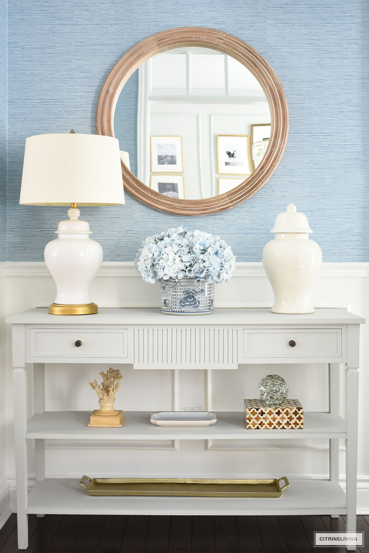 Spring decor styled on a grey console table with ginger jars, hydrangeas and other decorative accessories.