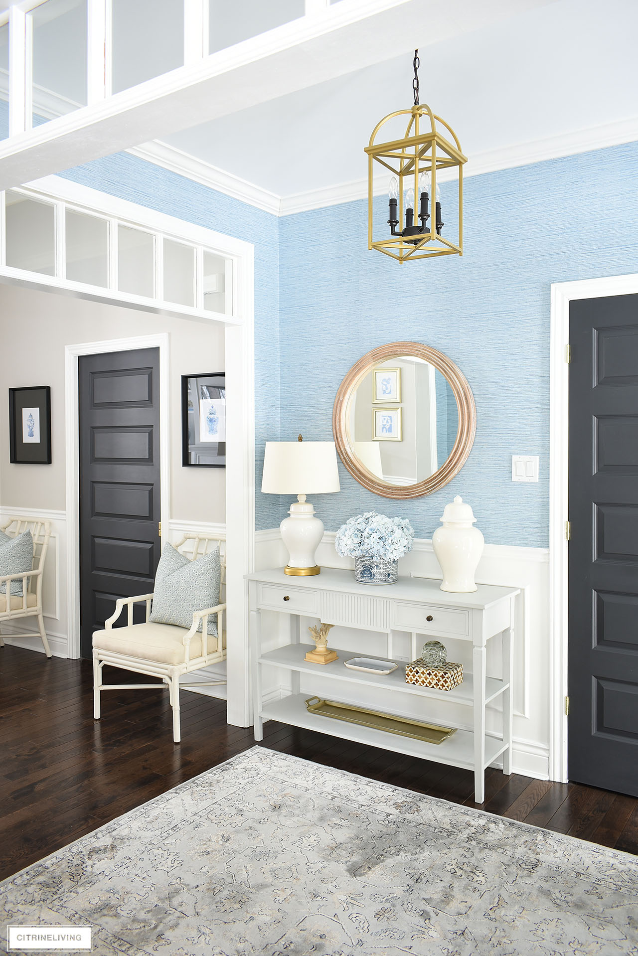 Gorgeous entryway decorated for spring with a soft and elegant light blue and white color palette.