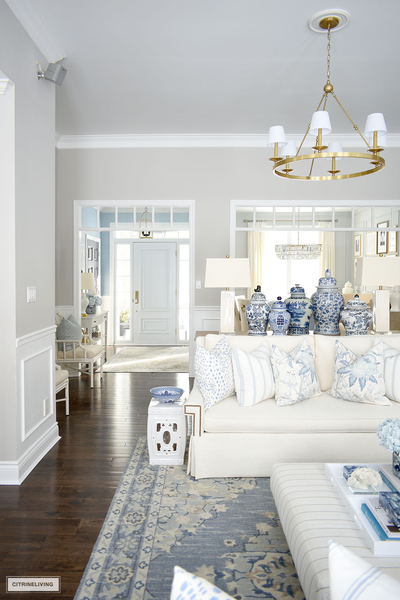 Living room decorated for spring with a gorgeous color palette using blue and white and chinoiserie accents.