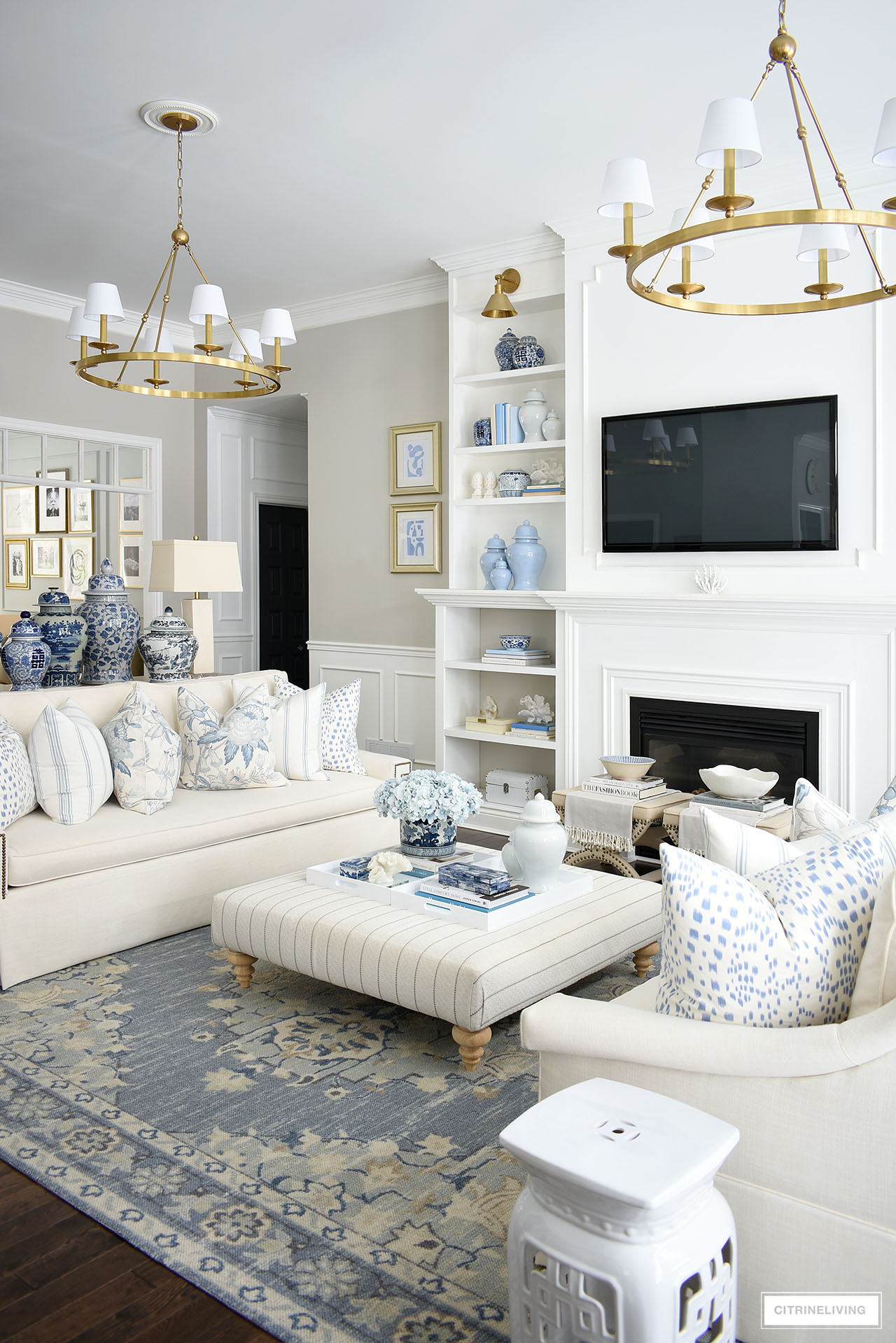 Living room spring decor with pretty blue and white pillows, rug, ginger jars and accessories.