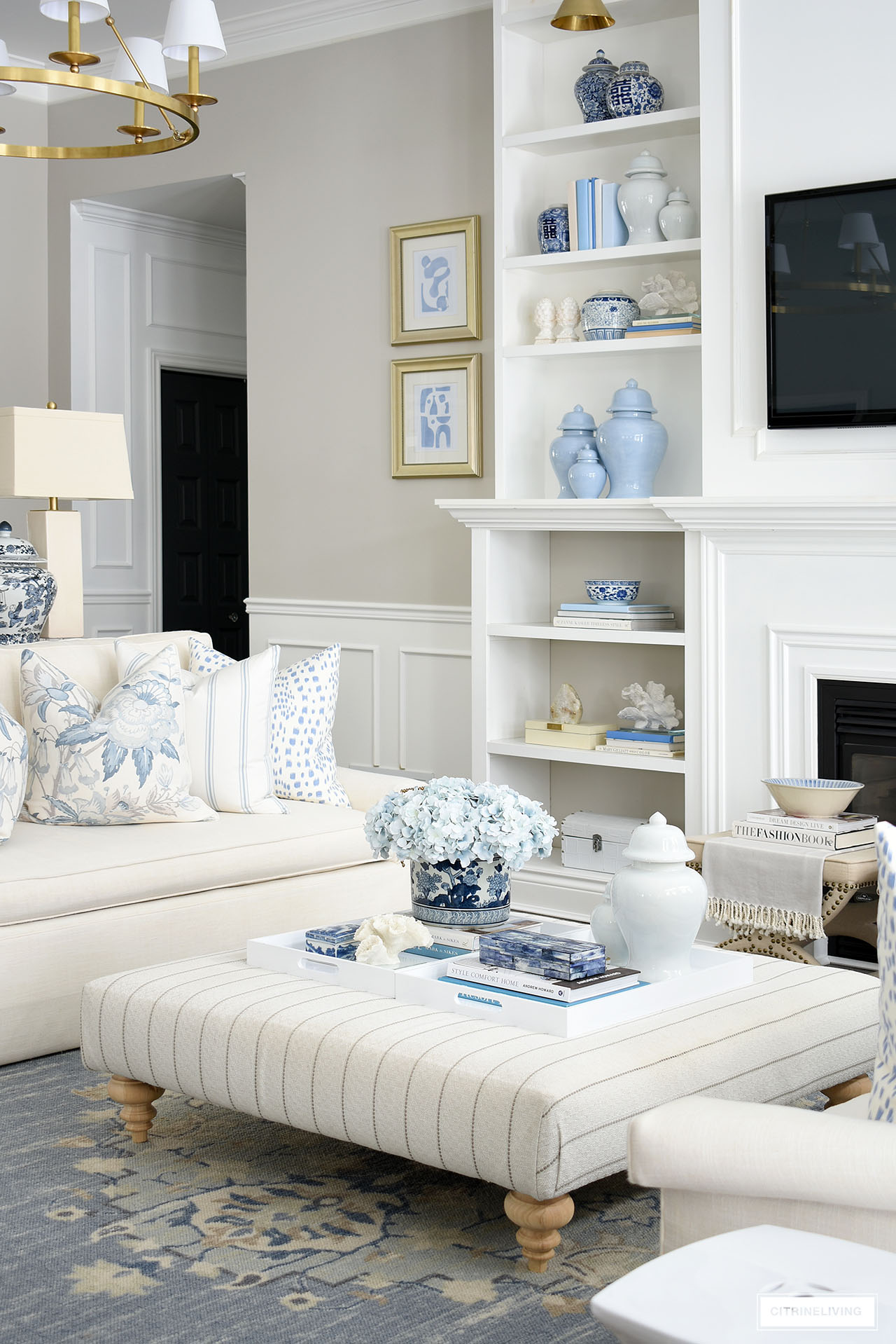 Living room styled for spring with blue and white accessories and pillows.
