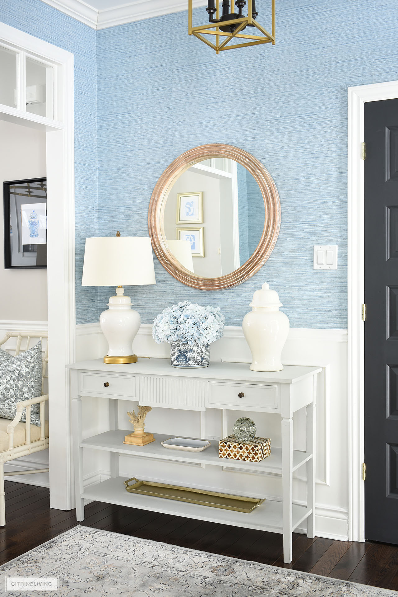 Entryway console table styled for spring with light blue and white accessories.
