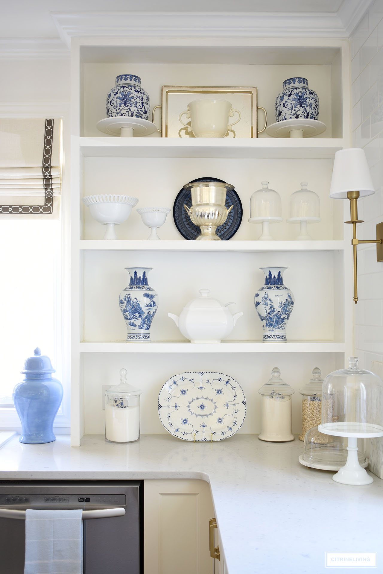 Open kitchen shelves decorated for spring with beautiful blue and white accents.