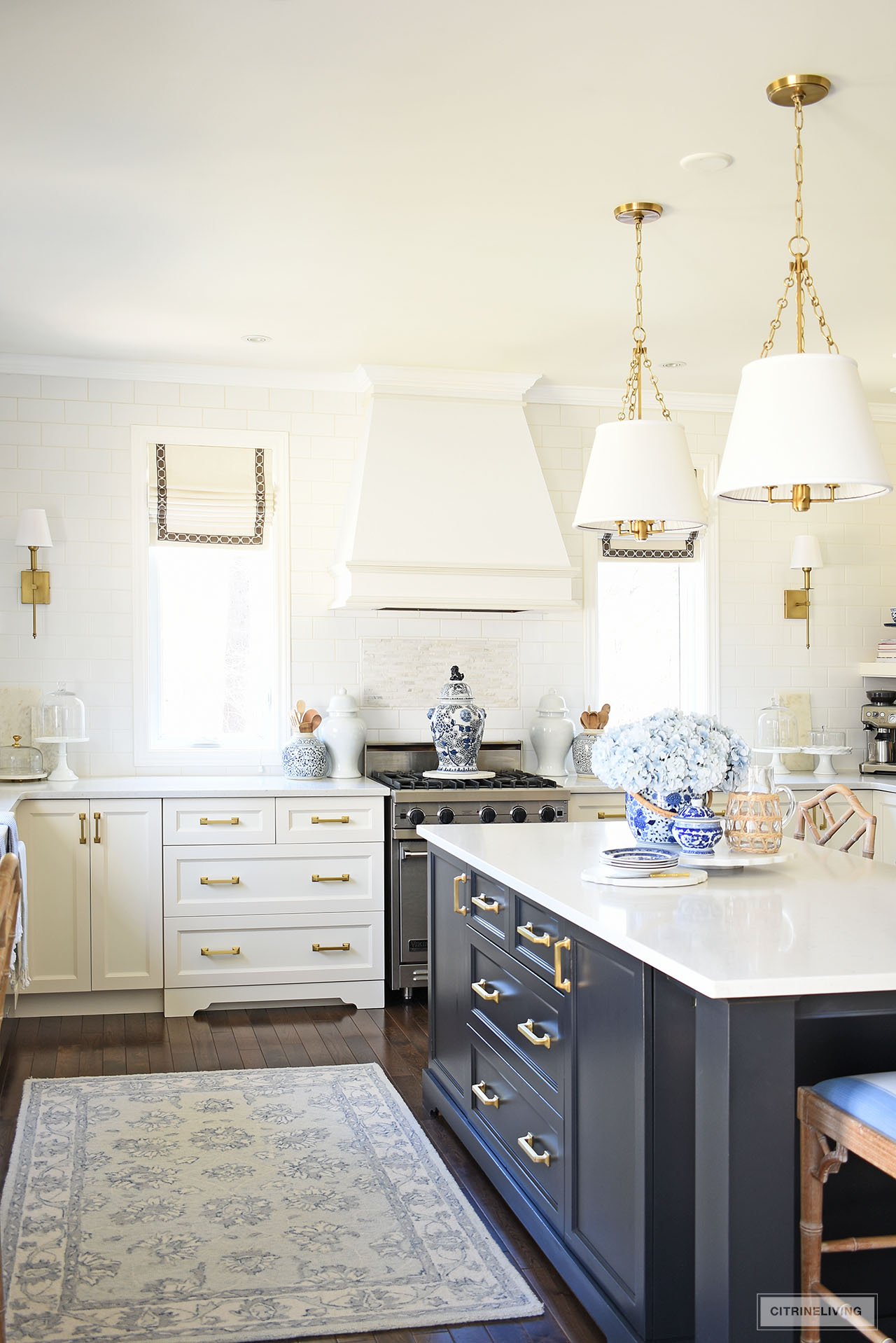 Beautiful white and black kitchen styled for spring with blue and white chinoiserie pieces, faux flowers and ginger jars.