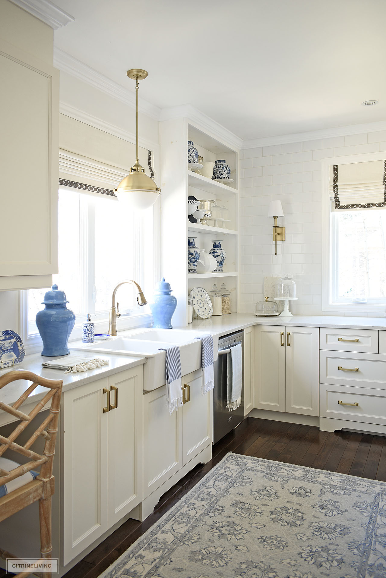 Kitchen sink and open shelving decorated with a beautiful blue and white color palette.