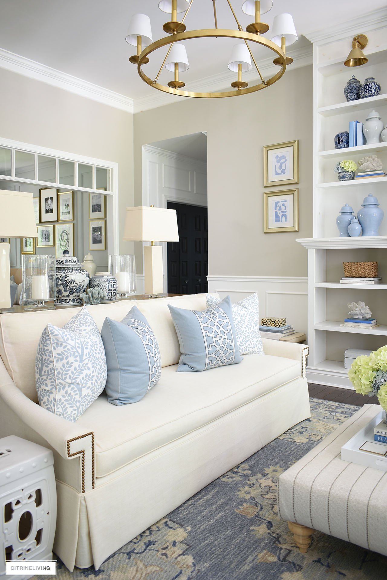 White sofa with blue and white pillows styled for summer.