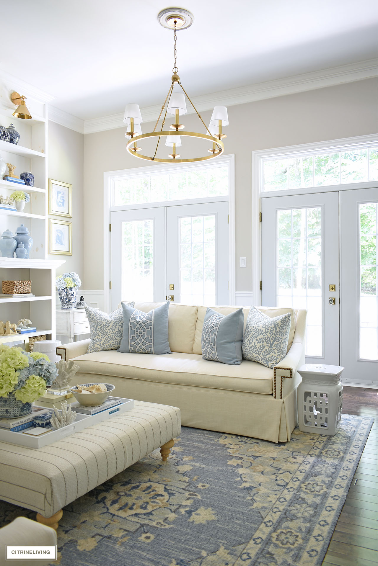 Living room decorated for summer with a soft blue and white color palette, natural accents and coastal touches.