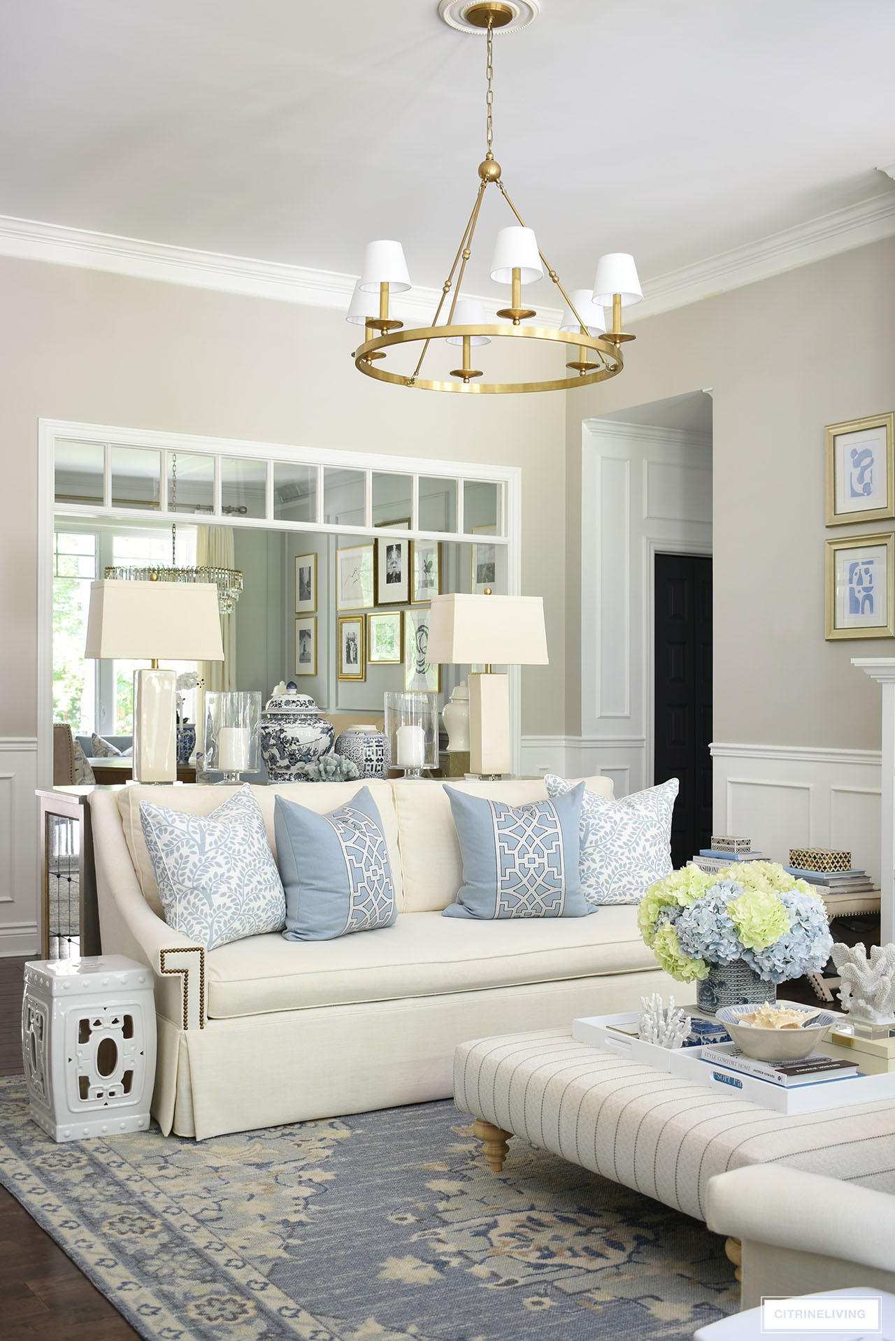 Traditional home with elegant summer decor in light blues and warm whites accented with coastal elements and light blue and light green hydrangeas.