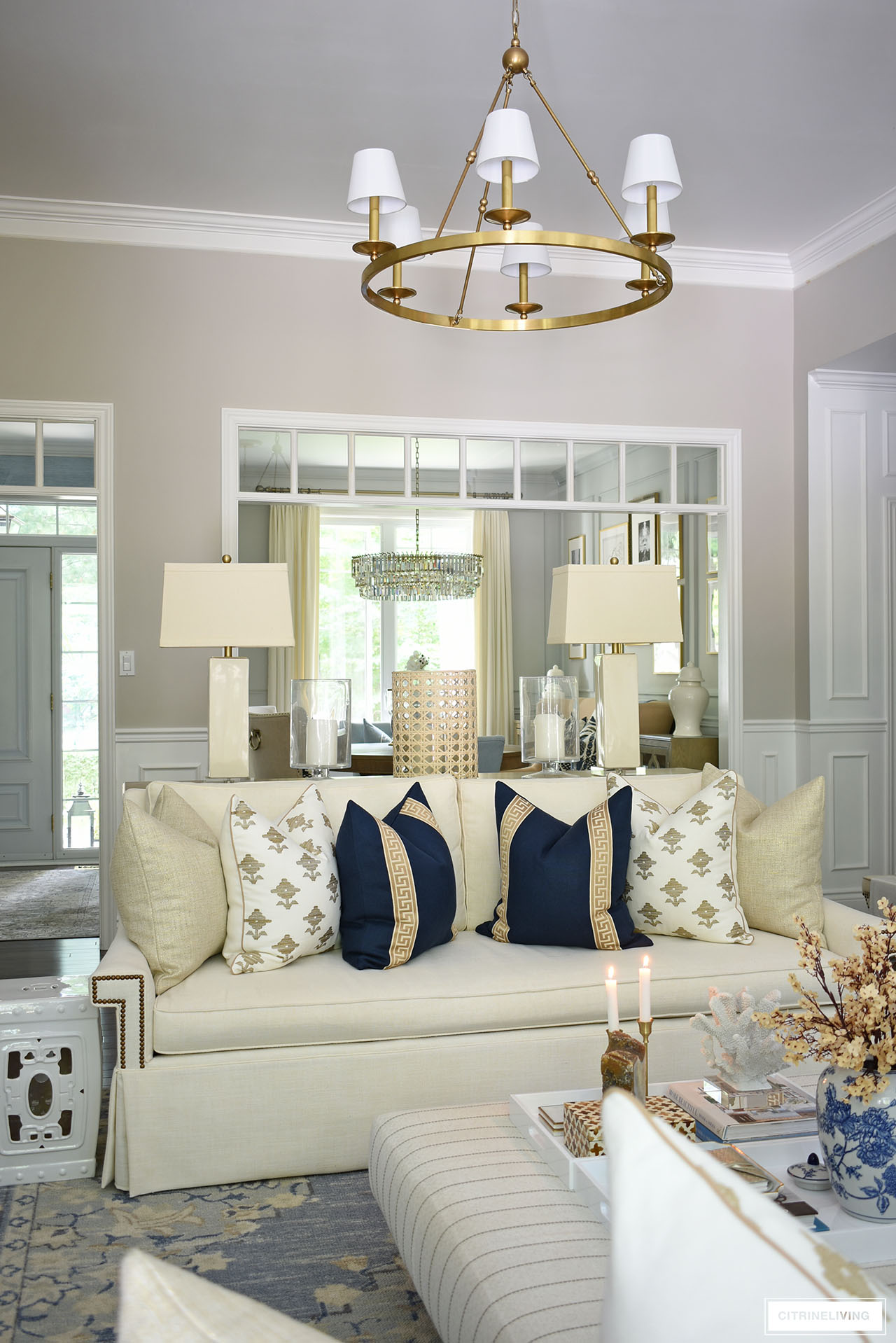 Fall living room decor with rich colors in navy and tan paired with gold and warm white.