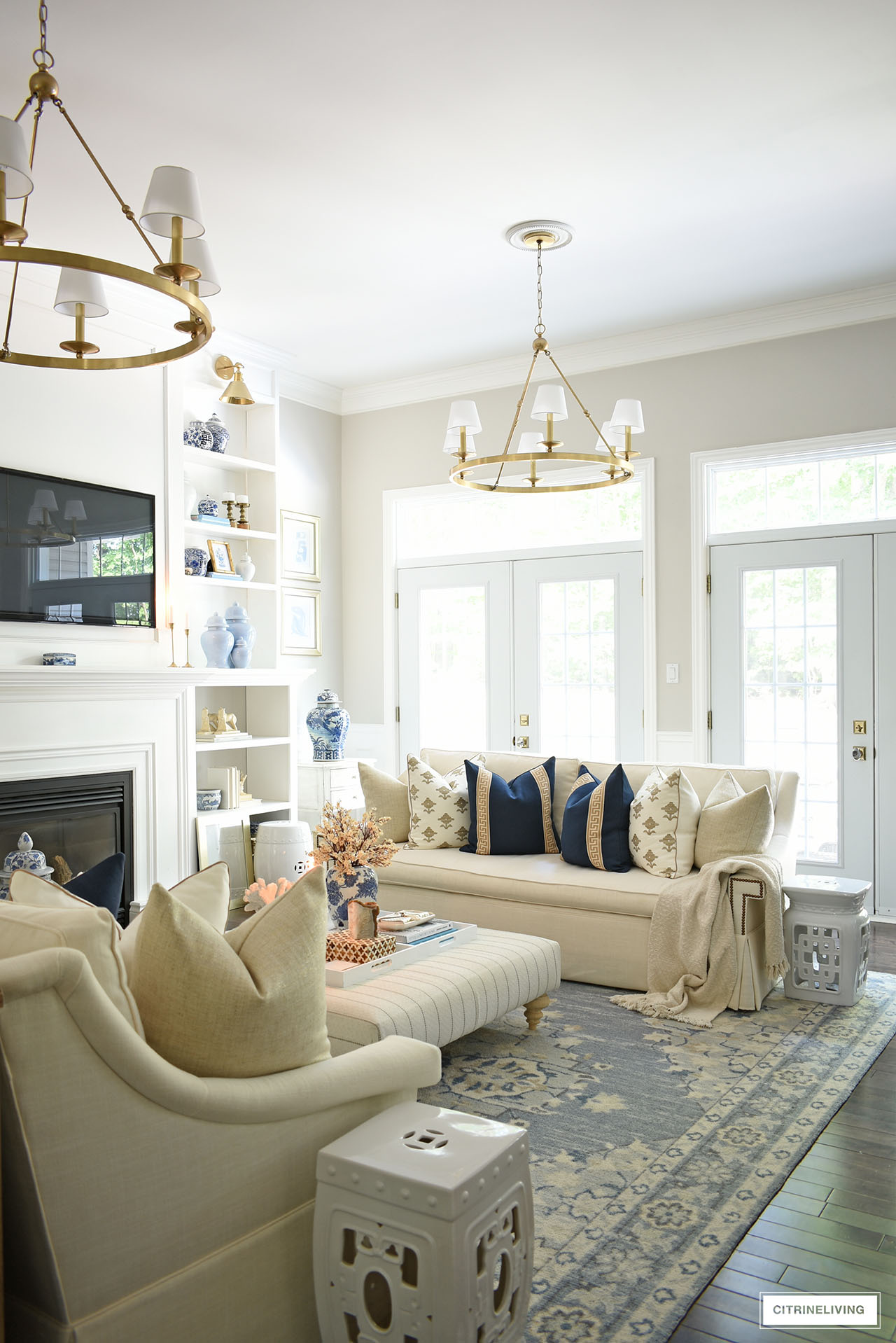 Elegant fall living room decorated with navy blue, tan, warm white and gold accents.