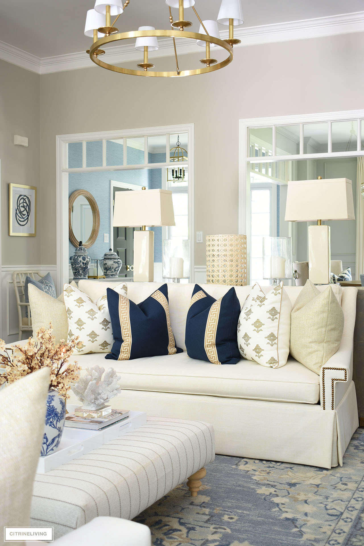 Gorgeous living room styled with elegant fall touches - navy and tan pillows. faux flowers, candles and natural textures.