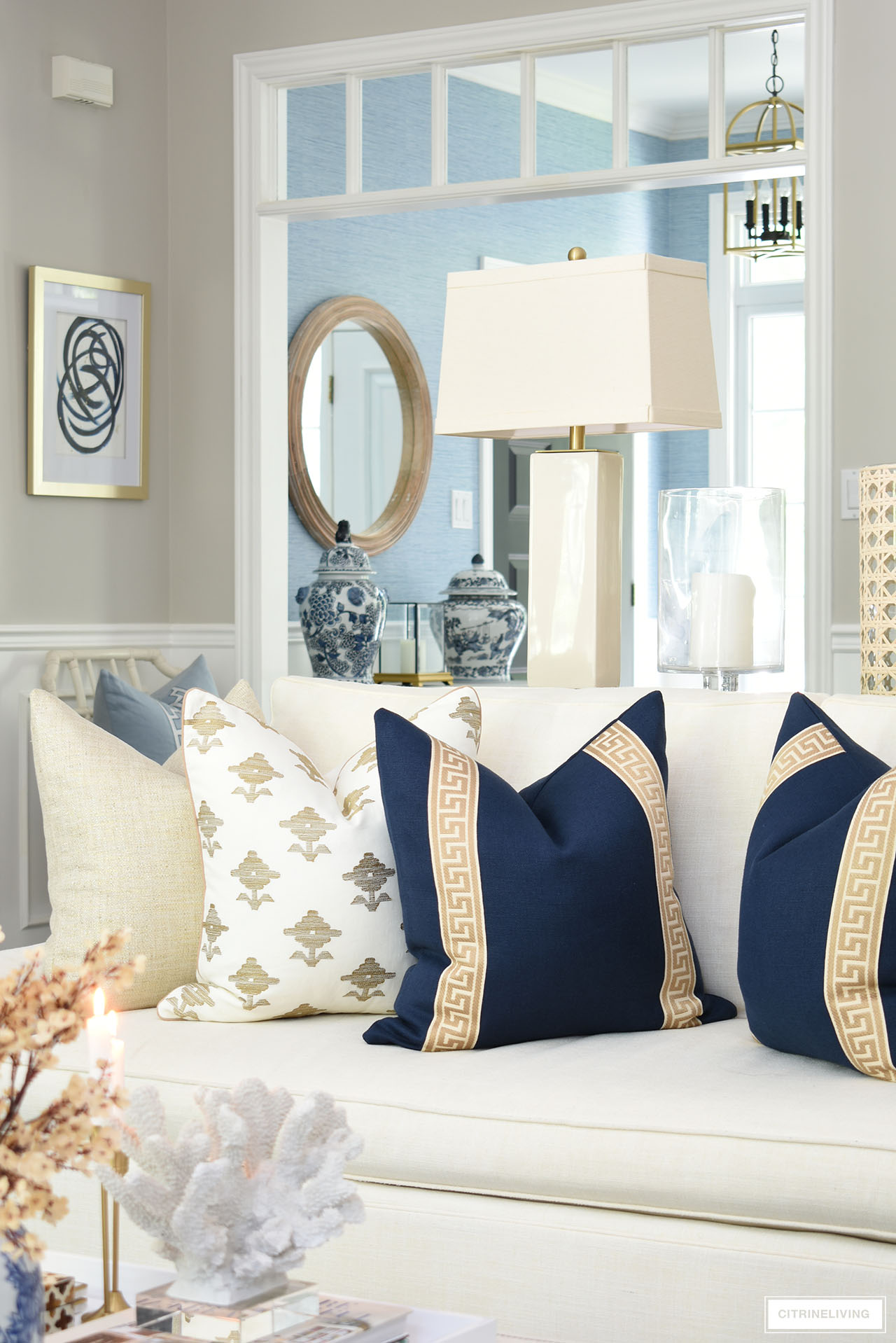 Gorgeous designer throw pillows in navy blue, tan and ivory, styled for fall.