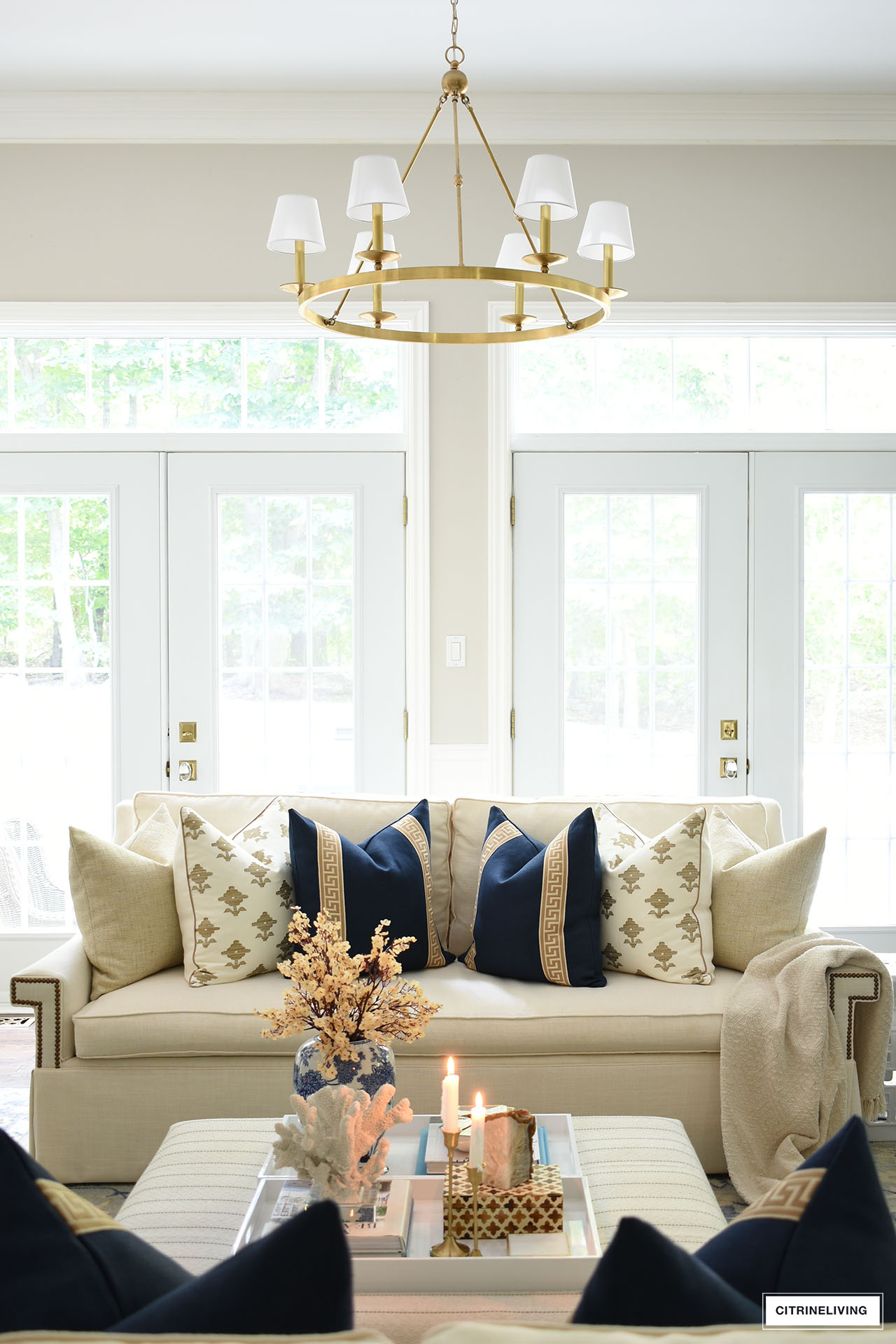 Beautiful fall living room decor with elegant navy blue, tan and ivory pillows. 