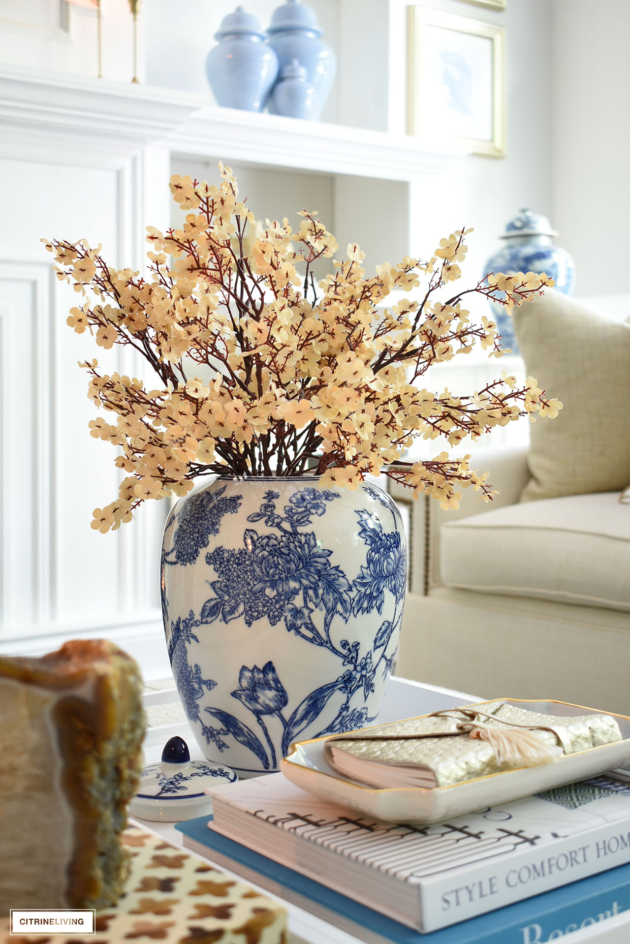 Dainty champagne faux flowers styled in a blue and white chinoiserie ginger jar for fall.