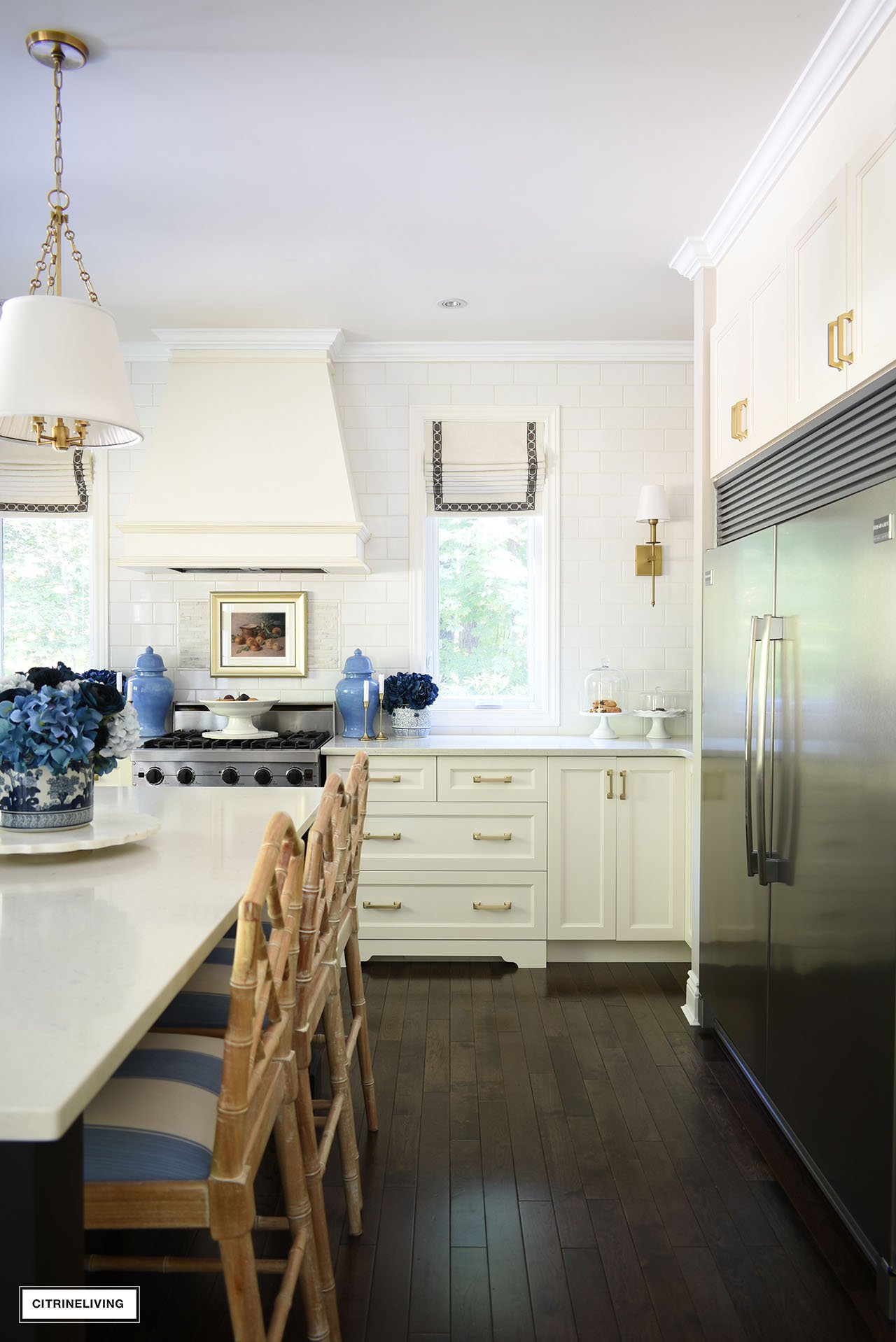 Beautiful fall kitchen decorated with blue florals, gold accents and vintage art.