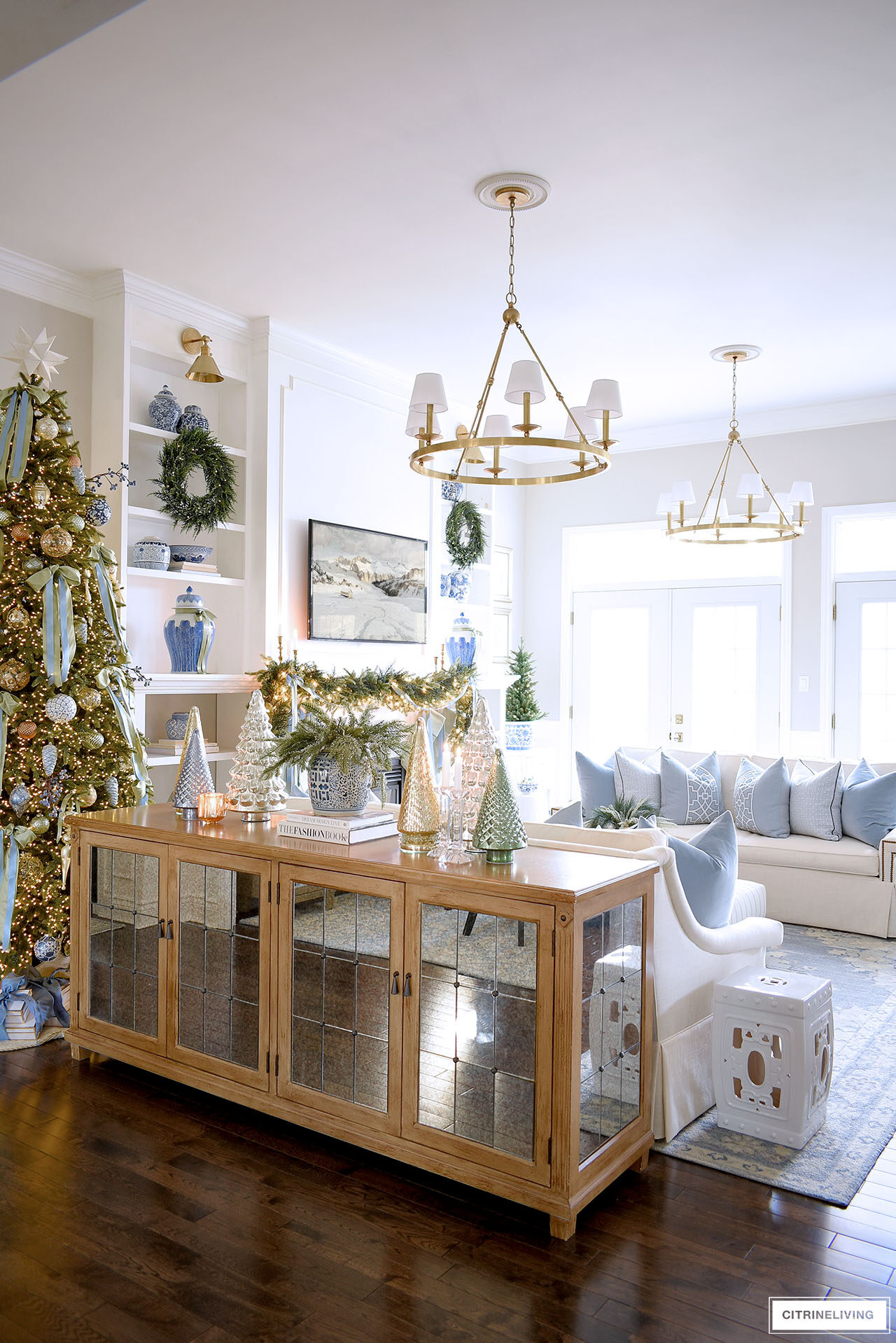 Living room decorated for Christmas with greenery, blue and white chinoiserie.