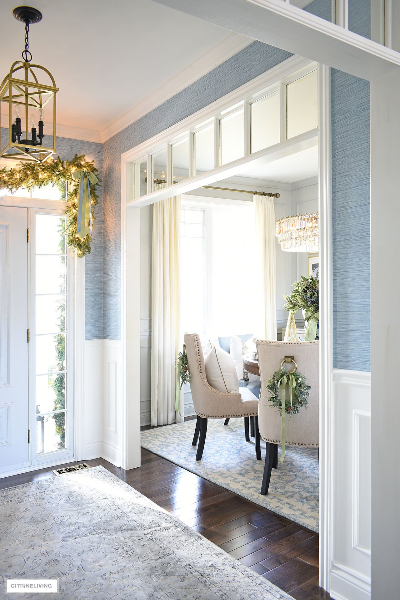 View of a dining room decorated for Christmas with simple greenery accents