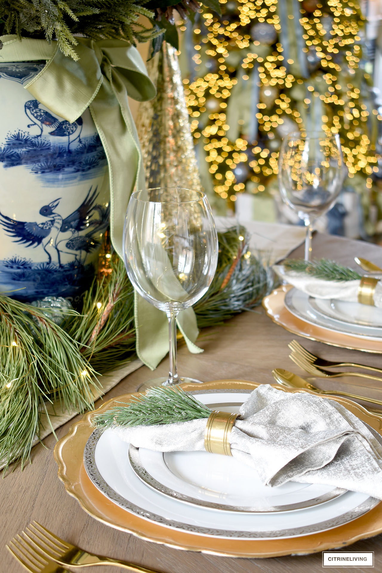 Silver and gold table setting for Christmas with touches of simple greenery