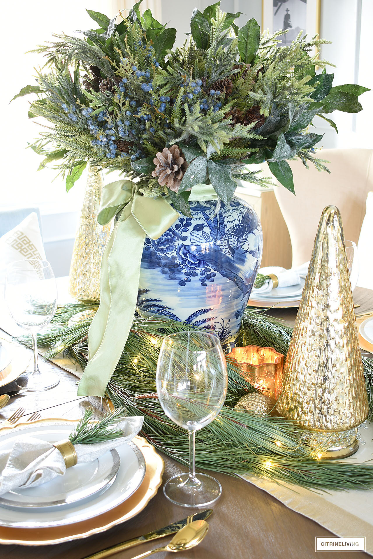 Christmas tablescape with greenery, silver, gold and blue and white chinoiserie