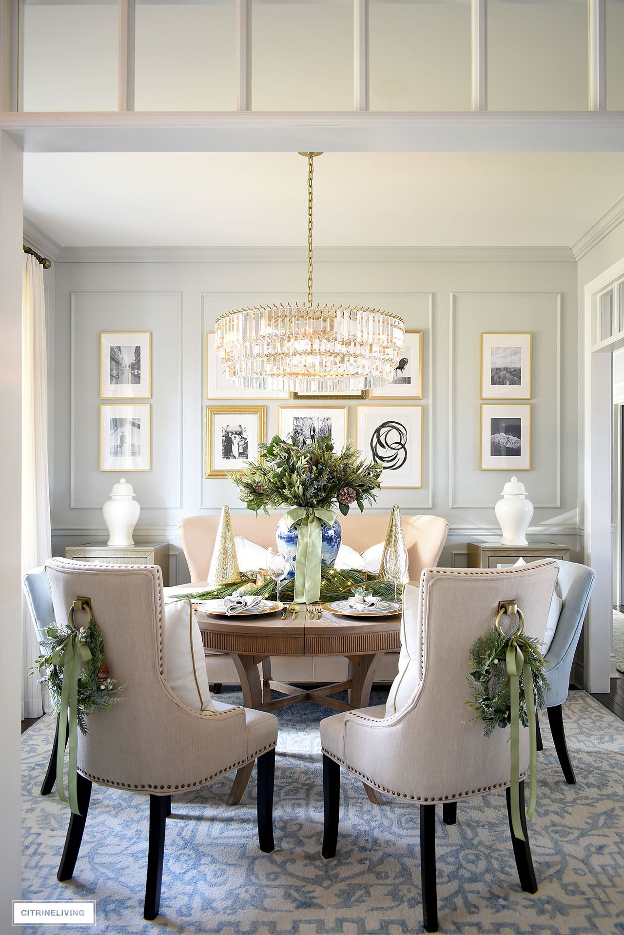 Dining room decorated for Christmas with accents of greenery throughout.