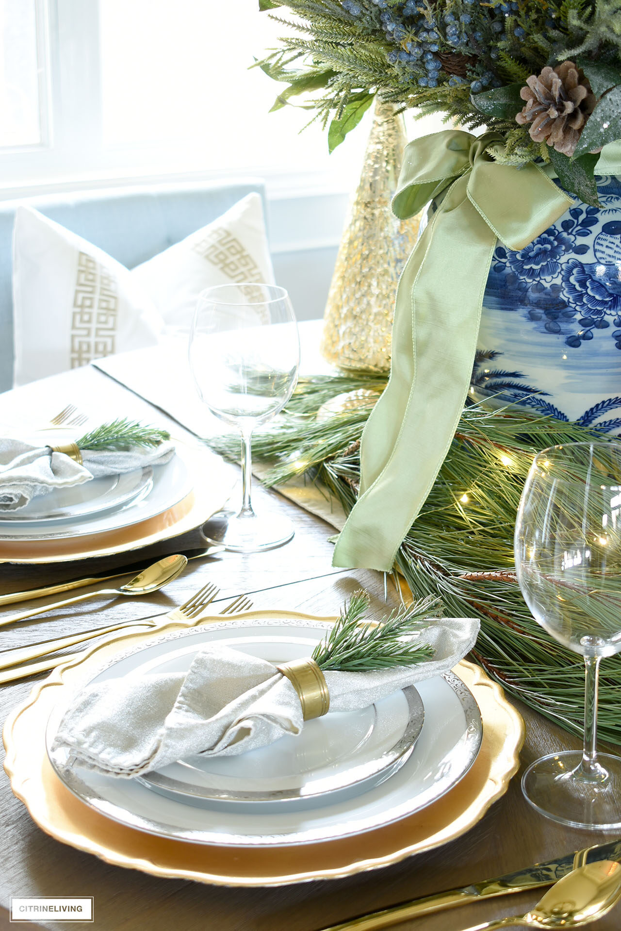 Silver and gold table setting for Christmas, greenery accents adds an elegant touch