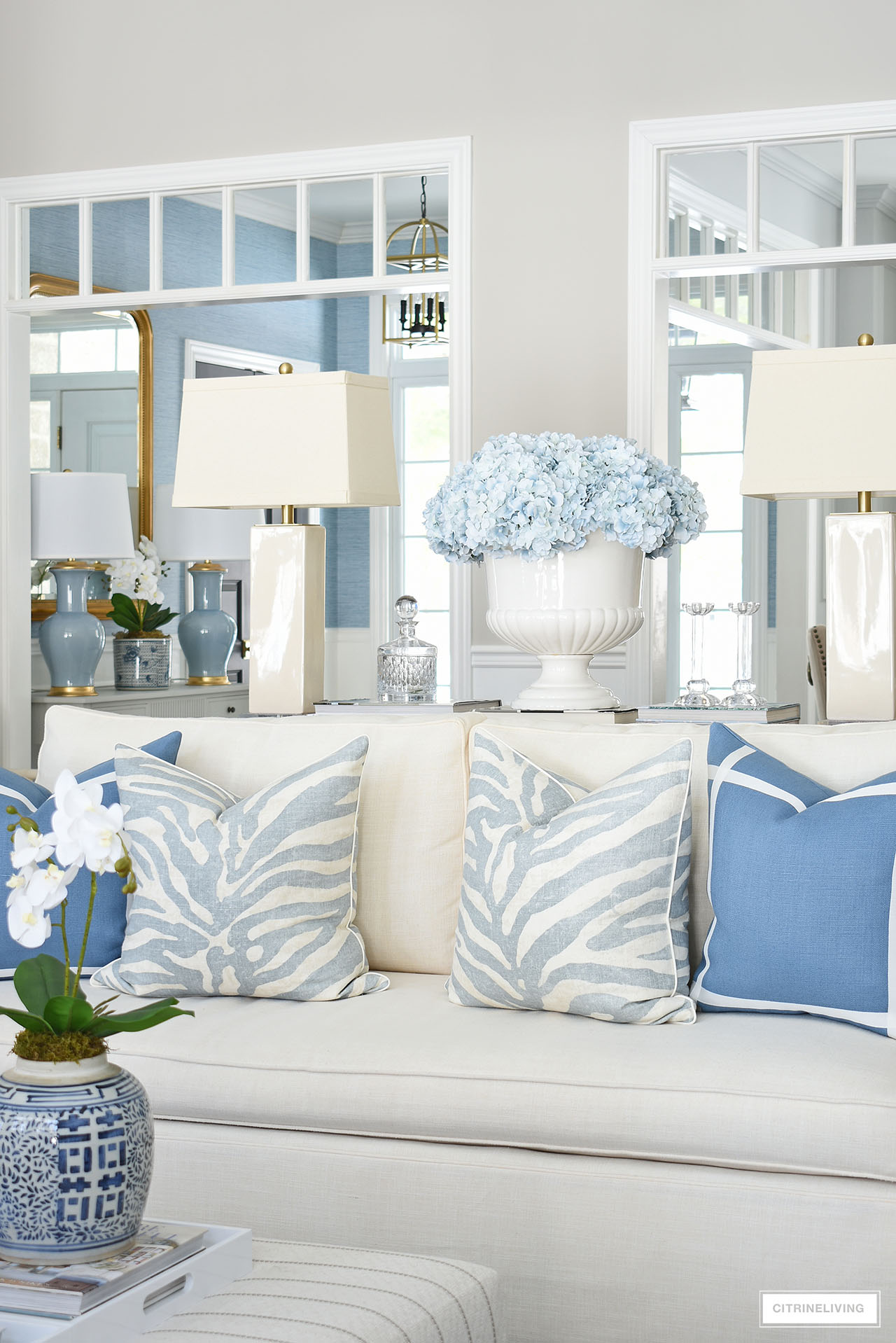Living room decorated for spring with large light blue faux hydrangea arrangement.