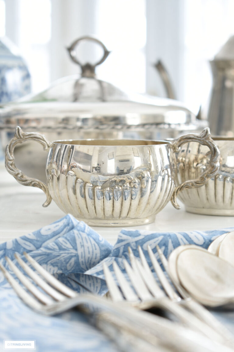 Polished silver creamer and silverware