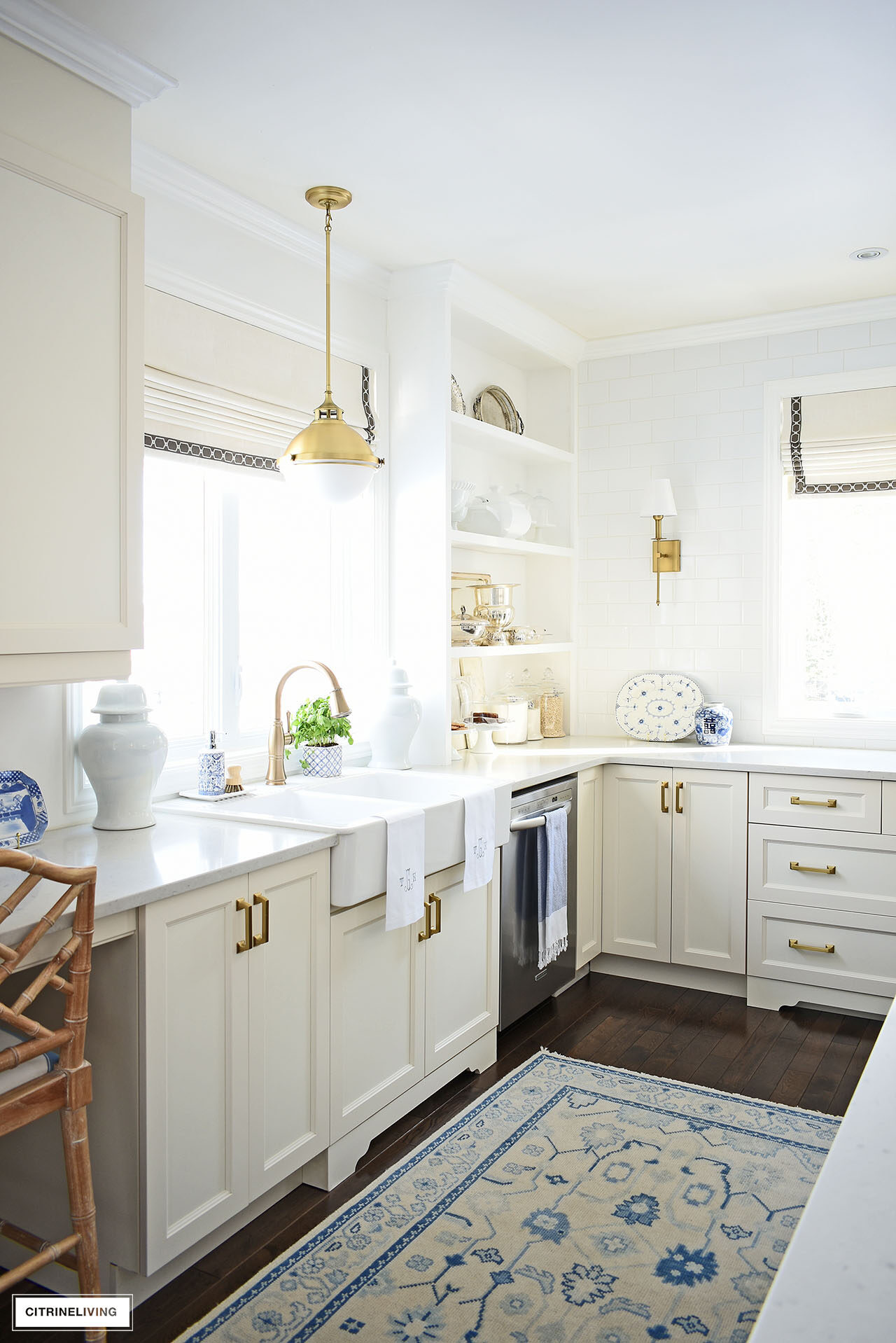 Elegant kitchen styled for spring with simple and classic decor - silver serving pieces, blue and white chinoiserie, ginger jars and monogrammed towels.