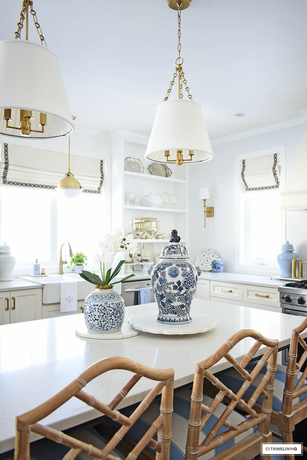 White kitchen decorated for spring with blue and white ginger jars and an elegant orchid arrangement.