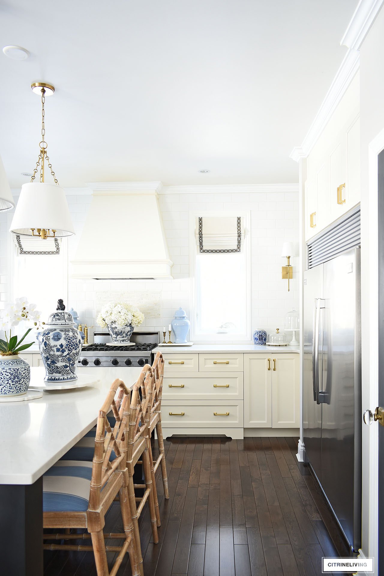 Classic kitchen decorated for spring with simple touches in blue and white, orchids, hydrangeas and ginger jars.