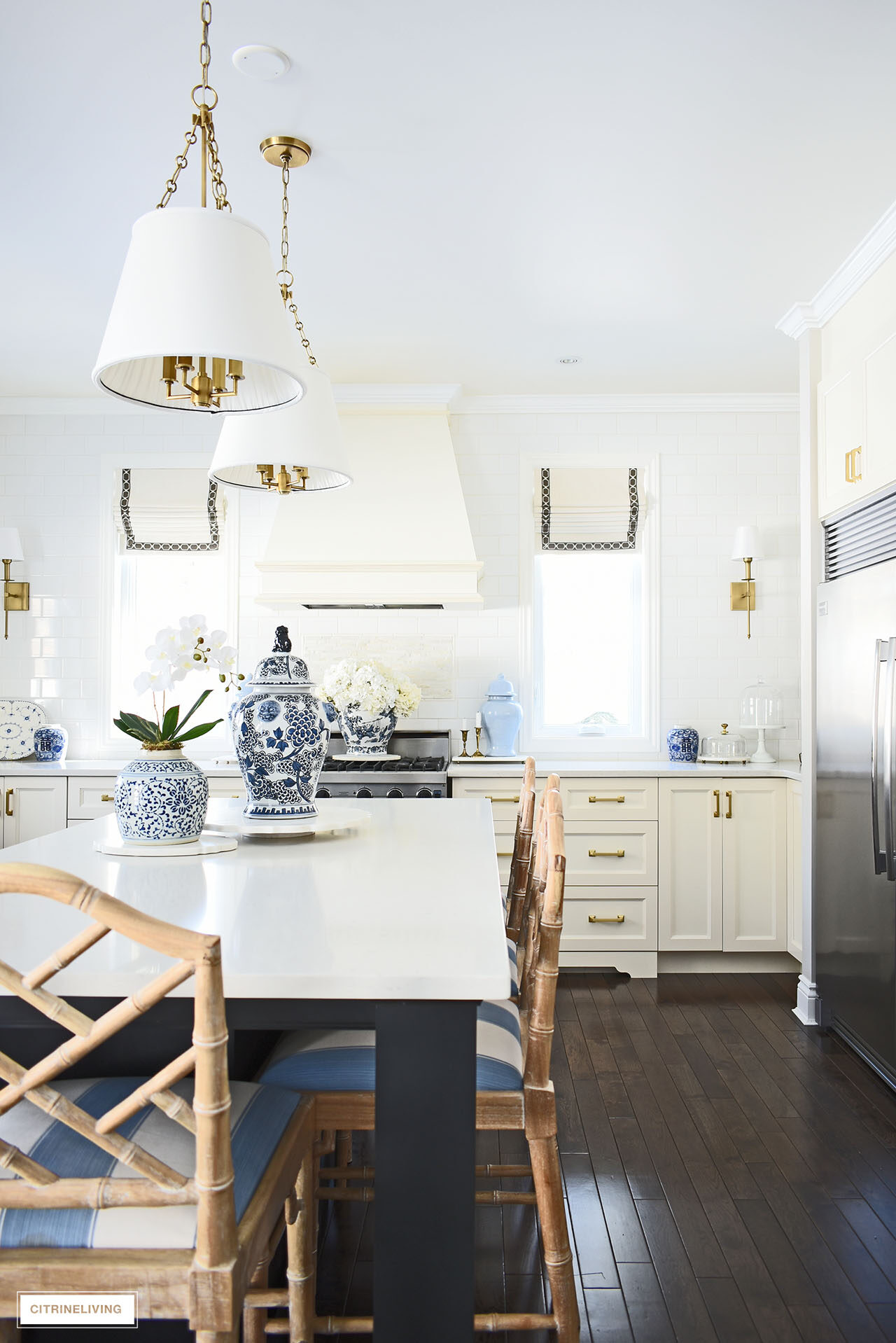 White kitchen decorated for spring with simple touches in blue and white, orchids, hydrangeas and ginger jars.