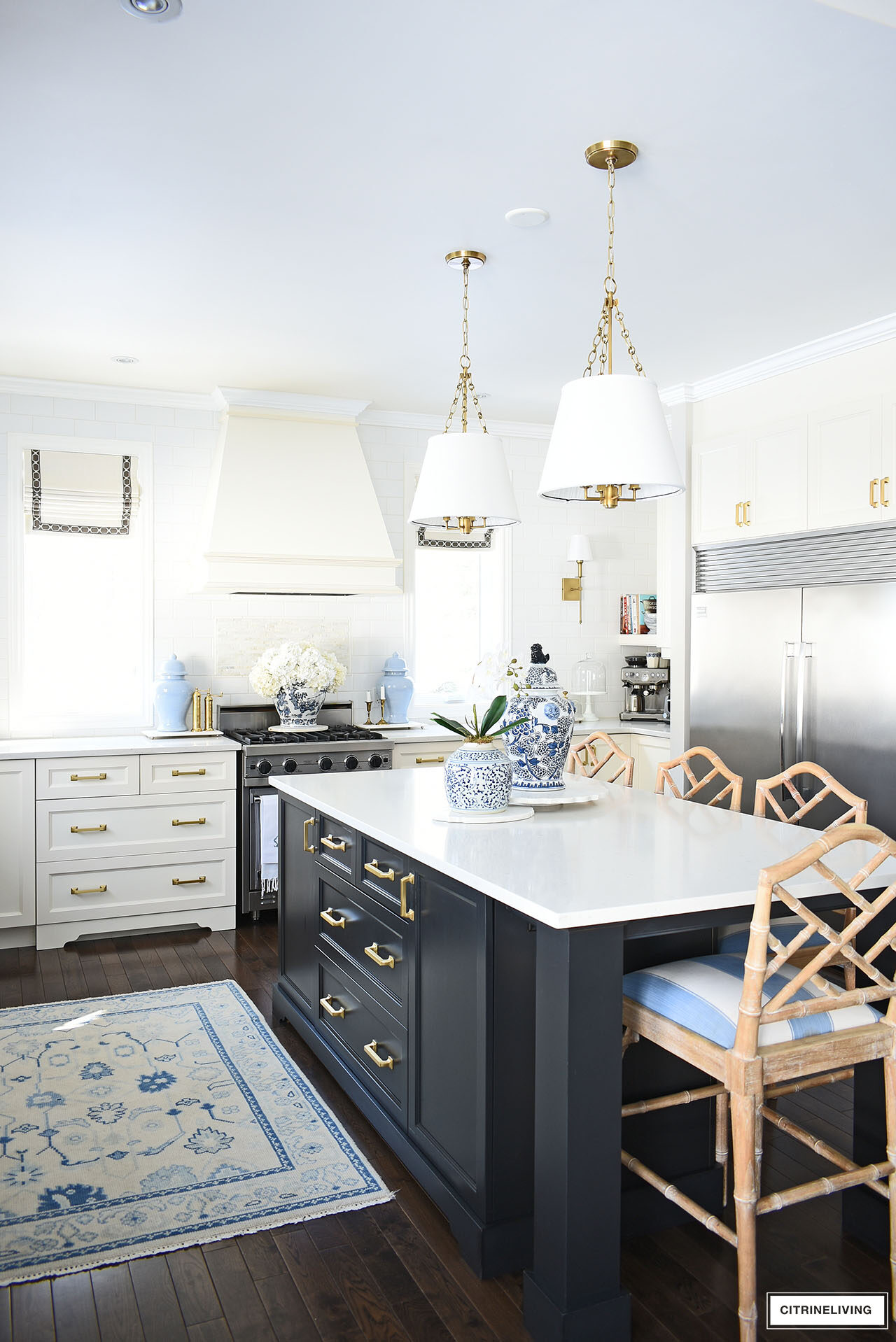 Kitchen styled for spring with blue and white ginger jars, white orchids and hydrangeas.