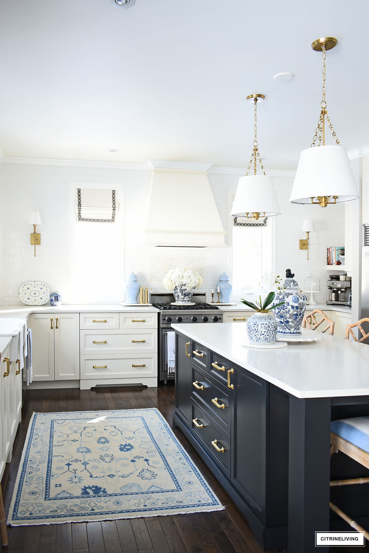White and black kitchen decorated for spring with simple touches in blue and white, orchids, hydrangeas and ginger jars.