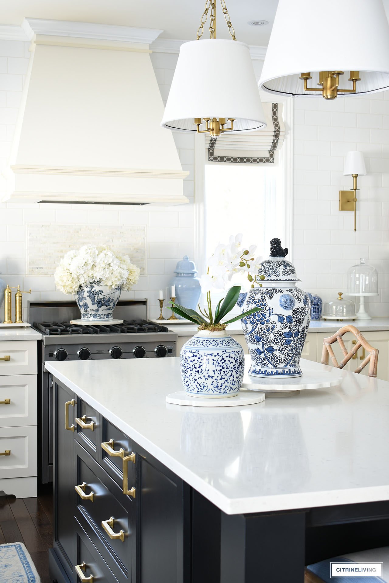 Kitchen island decorated for spring with blue and white ginger jars and an elegant orchid arrangement.