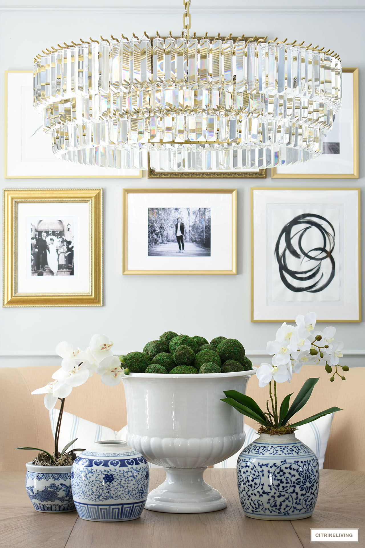 Dining room center piece with blue and white ginger jars. Large pedestal vase with moss balls.