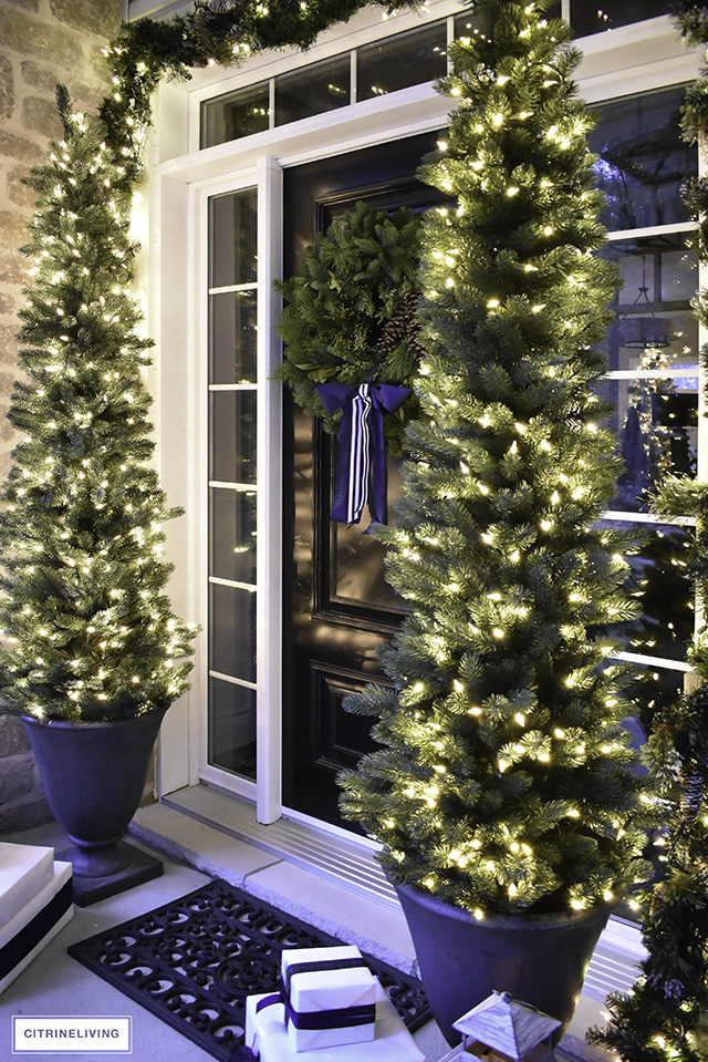 Set a magical scene and welcome your guests on your Christmas front porch this year with fresh greenery and the twinkle of white lights.