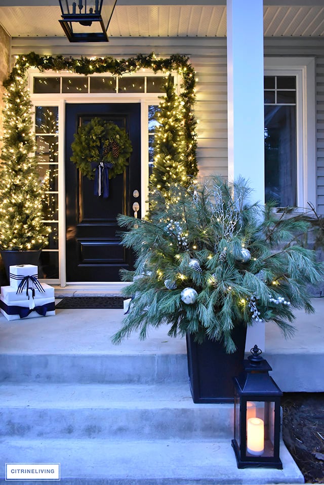 Set a magical scene and welcome your guests on your Christmas front porch this year with fresh greenery and the twinkle of white lights.