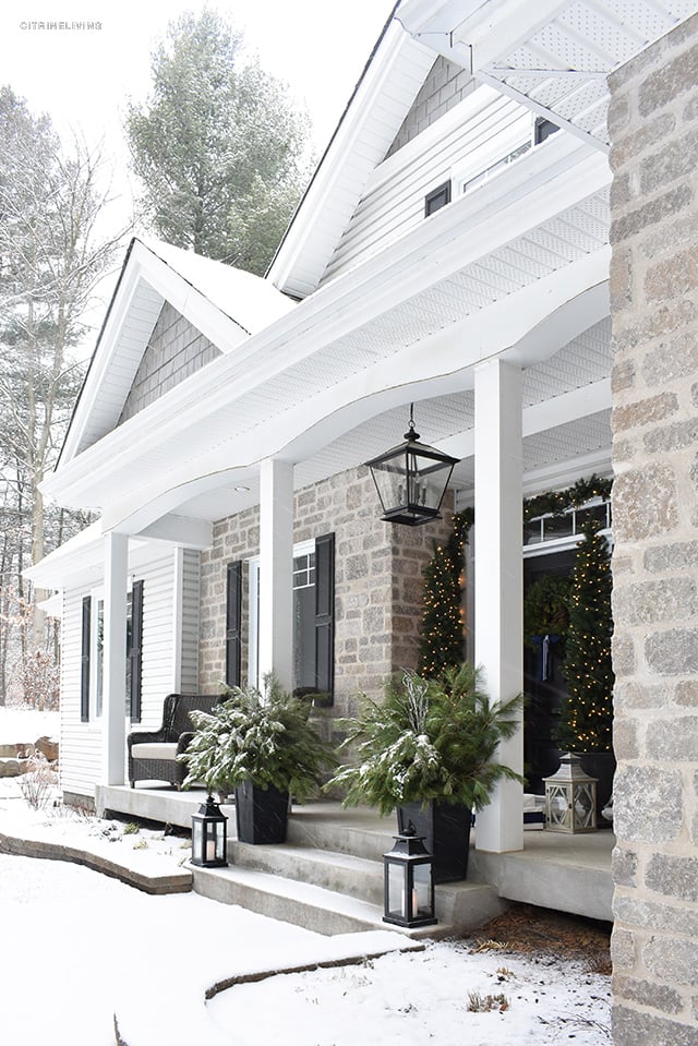 Set a magical scene and welcome your guests on your Christmas front porch this year with fresh greenery and the twinkle of white lights.