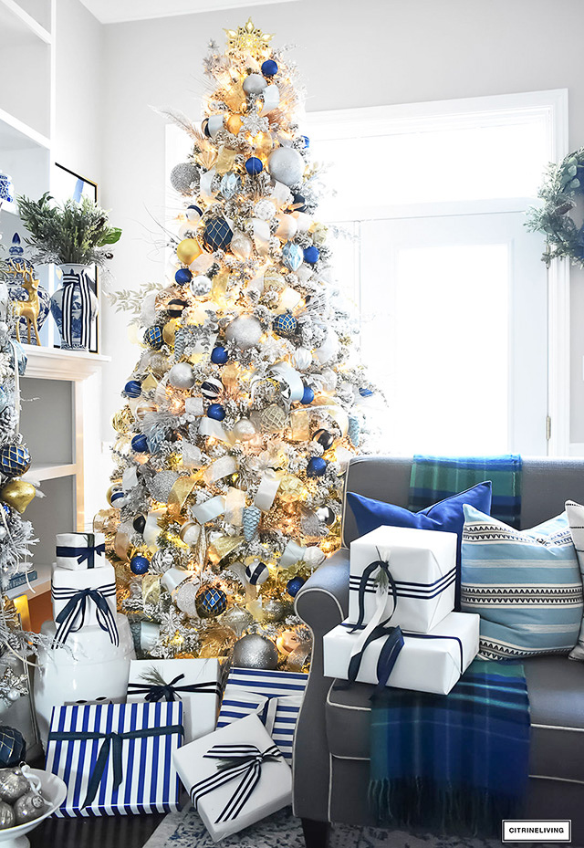 https://citrineliving.com/wp-content/uploads/2023/06/living-room-flocked-christmas-tree-navy-gold-silver-ornaments-tartan-throw-4.jpg