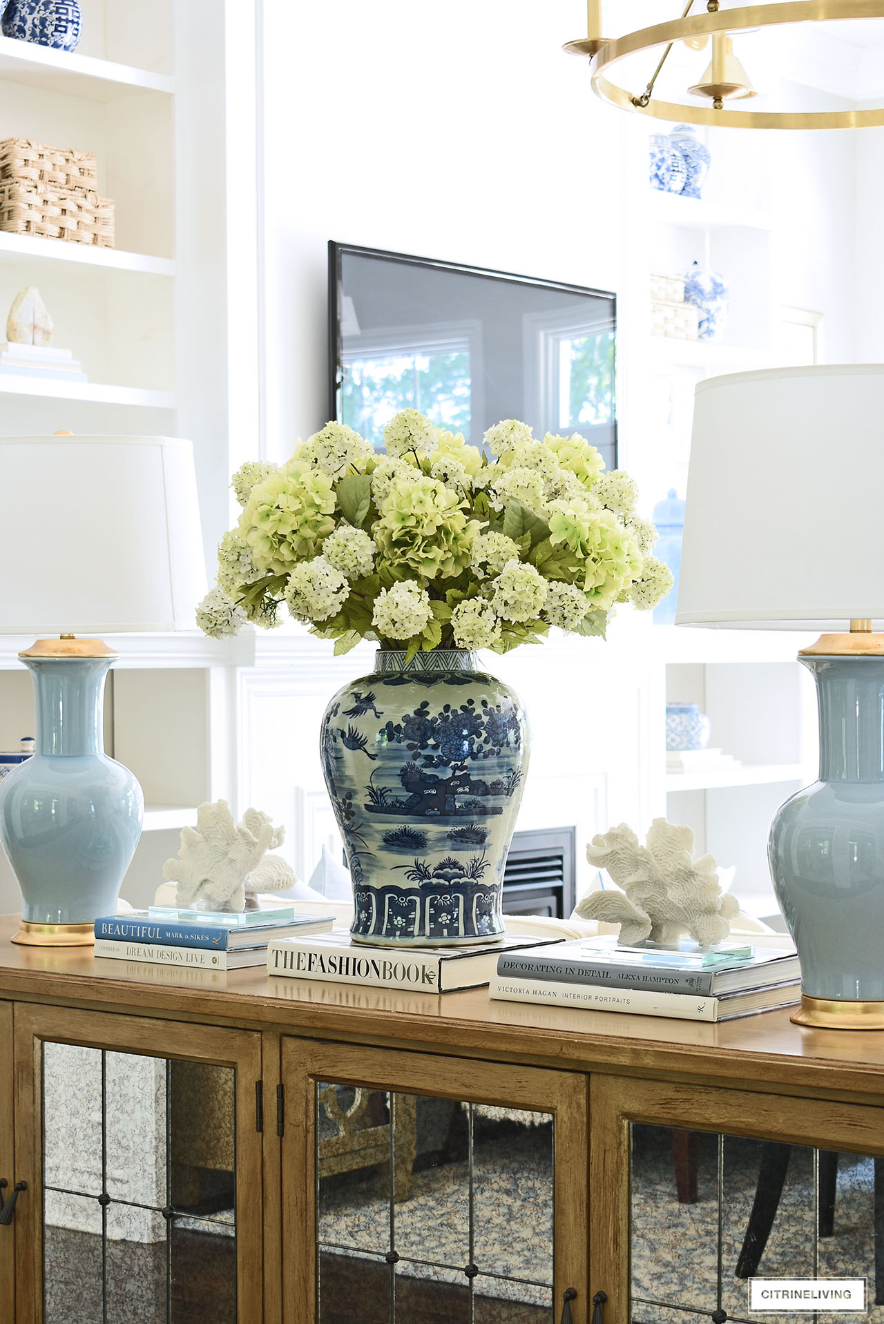 Light green snowball hydrangea arrangement in an oversized blue and white ginger jar.