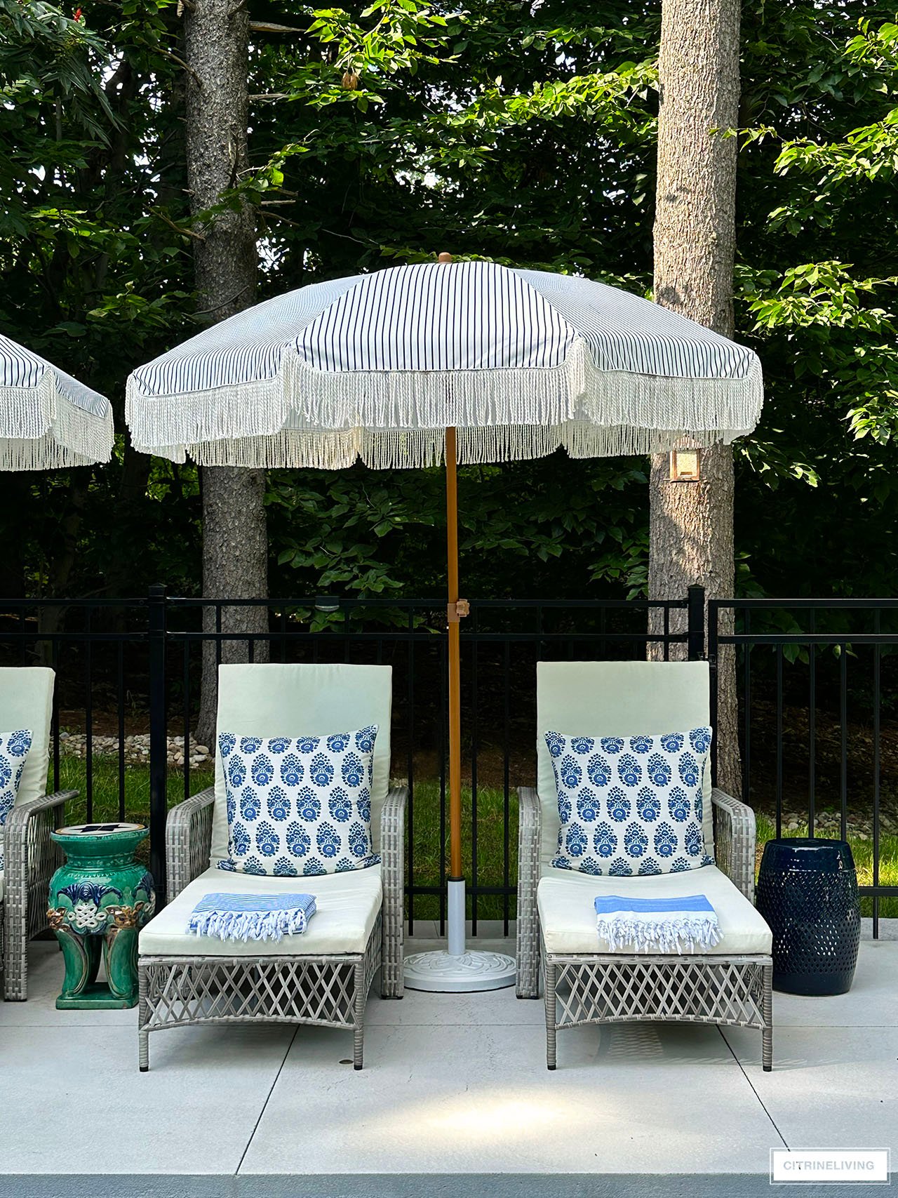 Resort style pool with loungers and fringe umbrellas.