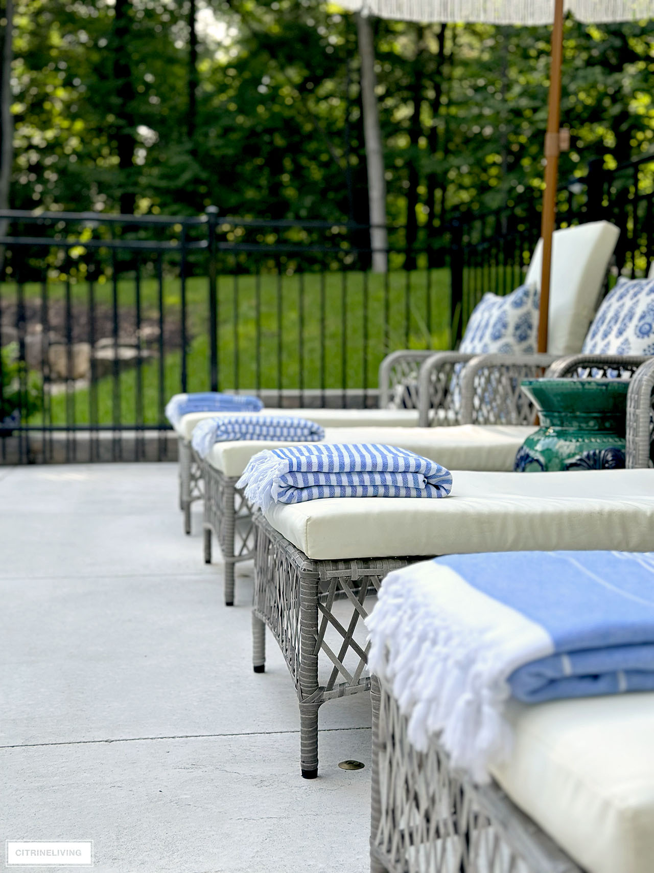 Striped towels styled on pool loungers.