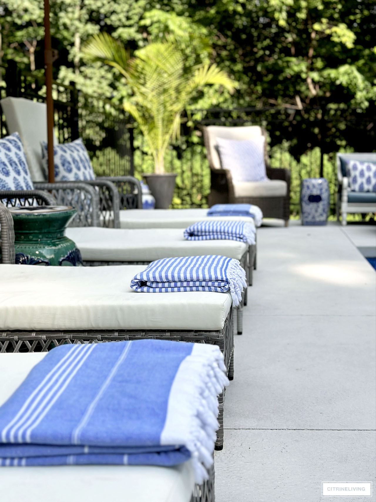Striped towels styled on pool loungers.