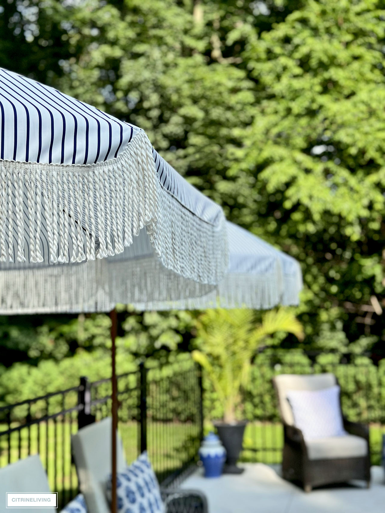 Striped patio umbrellas with fringe.