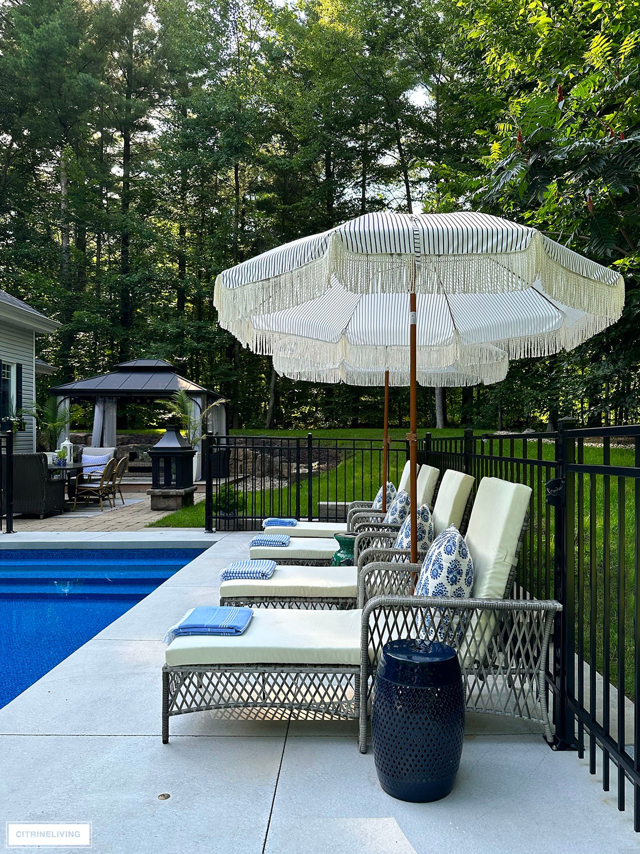 Pool deck featuring resort style loungers and umbrellas