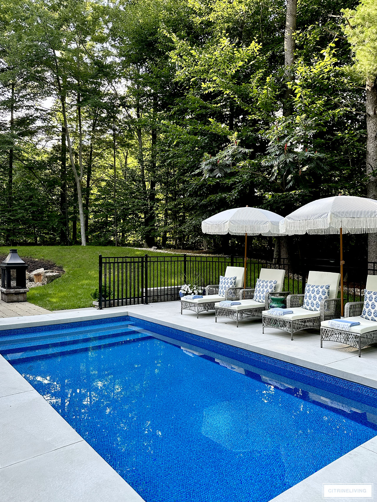 Resort style in ground pool with loungers and umbrellas