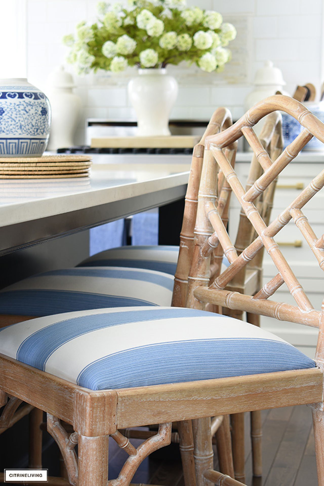 Natural wood toned bar stool upholsetred with blue and white striped fabric